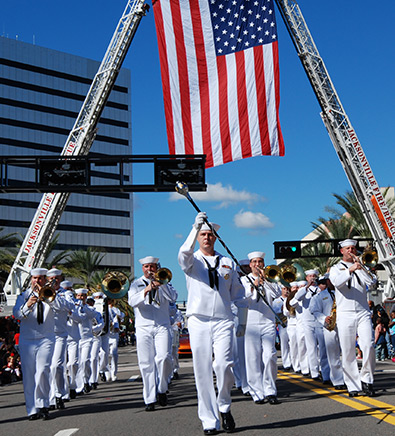 Sailors marching under American Flag